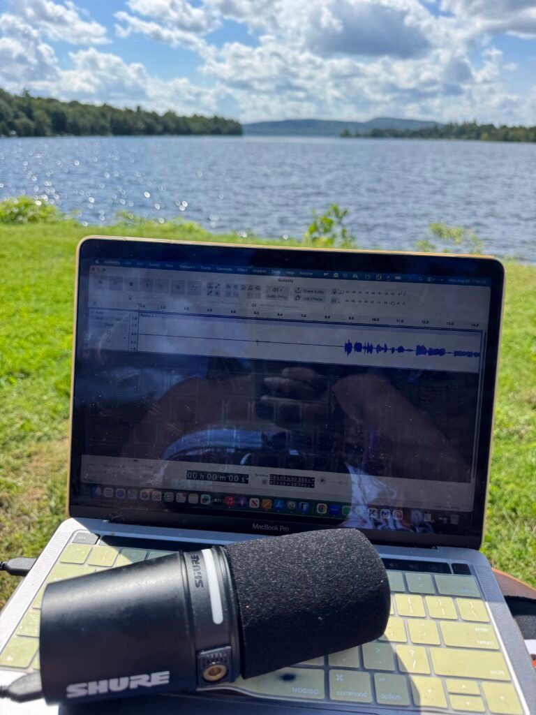 Lift OneSelf Podcast recording with microphone and laptop outdoors